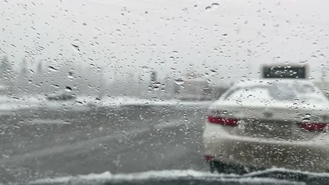 Sleet with rain falls on the windshield of the car. Stock Footage 152548010