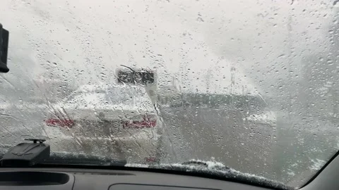 Sleet with rain falls on the windshield of the car. Stock Footage 152548015