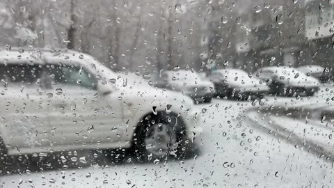 Sleet with rain falls on the windshield of the car. Stock Footage 152548017