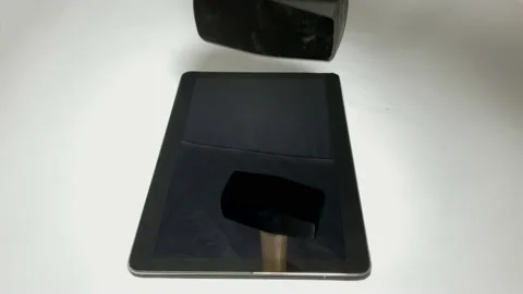 Slegehammer falls vertically onto a Tablet Video stock 150266509