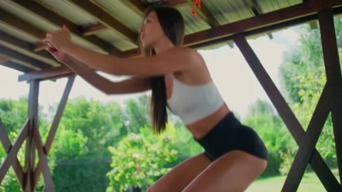 A slender brunette does an exercise on the buttocks, a girl is engaged in Stock Footage 137025021