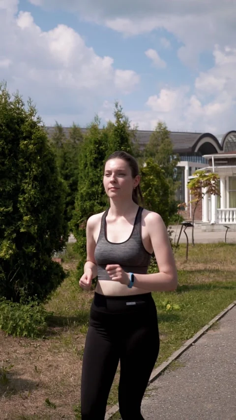 Slender dark-haired girl jogging Stock Footage 231259703