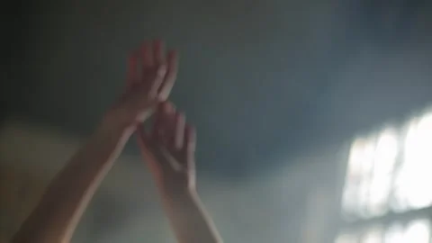 Slender female hands raised and crossed in atmospheric smoke or fog. Stock Footage 323077288