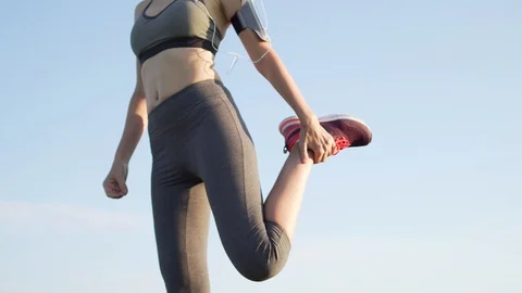 Slender female runner is preparing to run in the morning to the music. The runne Stock Footage 115981286