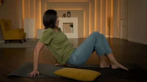 Slender girl doing exercises lying on the floor Stock Footage 152998288