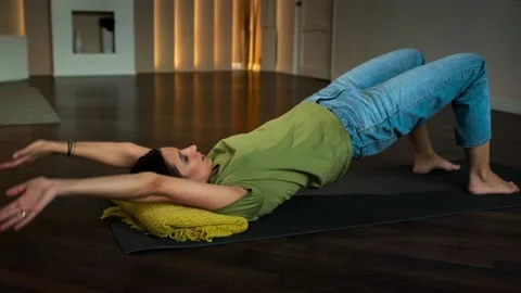 Slender girl doing exercises lying on her back Stock Footage 152998315