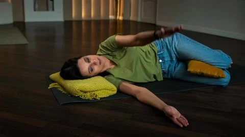Slender girl doing exercises lying on her back Stock Footage 152998324