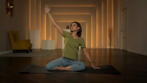 Slender girl doing exercises while sitting Stock Footage 152998300