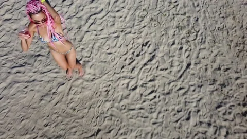 Slender girl in dreadlocks dancing on the sand in summer Stock Footage 135013098
