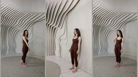 A slender girl teaches posing using body balance.  Stock Footage 314648249