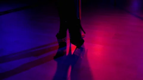 Slender legs of pole dancer in stripper shoes in the club. Pole dance. Stock Footage 152698975