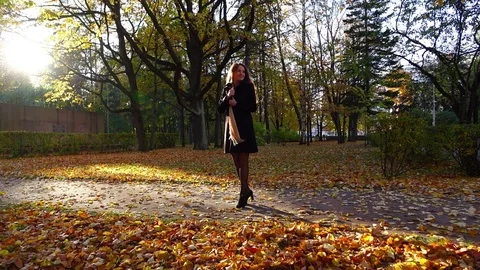 Slender woman feel happy, turn around in good spirits, nice autumn park Stock Footage
