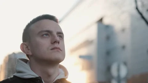 Slender young man looking up to the sky with faith in a better future Video stock 236939834
