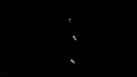 A Slew of White Pills Falls on a Table and Scatters Stock Footage 270388228