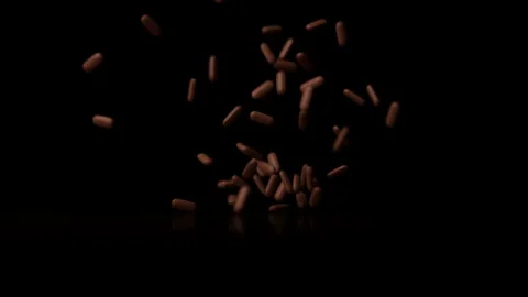 A Slew of Yellow Pills Fall on a Table and Scatters Stock Footage 270389417