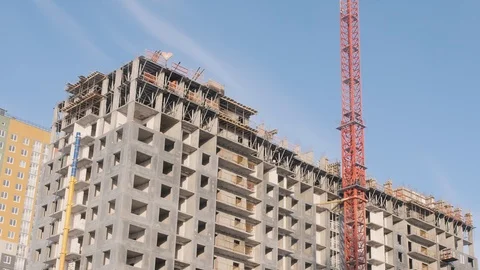 Slewing crane moves suspension hook above panel house Stock-Footage 124892313