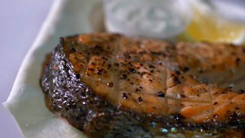 Slice of appetizing fish steak with lemon and sauce Video stock 152709031