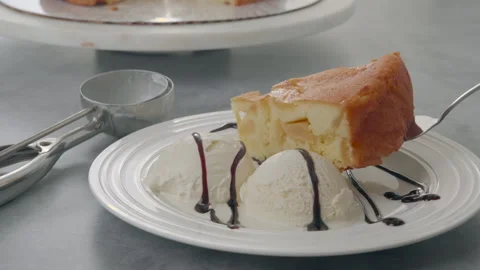 Slice of apple cake served with ice cream, whipped cream, and chocolate Stock Footage 265602276