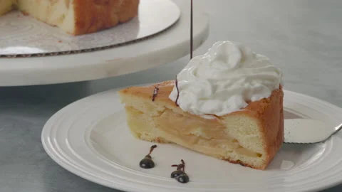 Slice of apple cake with whipped cream and chocolate topping Stock Footage 232634150
