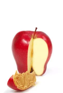 Slice of apple with peanut butter Stock Photos