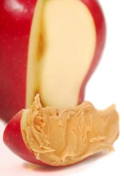 Slice of apple with peanut butter Stock Photos