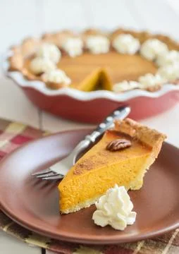 Slice of apple pie cake with spoon on a plate Stock Photos