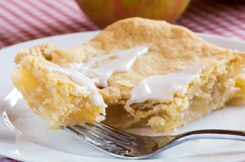 Slice of apple pie with fork Stock Photos
