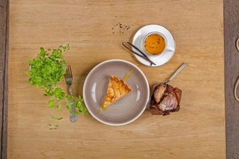 Slice of Apple pie with tea cake and cinnamon on wooden background Stock Photos