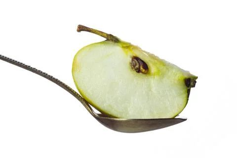 Slice of apple in spoon isolated on white Foto stock