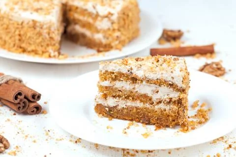 Slice of baked easter carrot cake with raisins and walnut Stock Photos