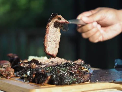 Slice of beef short rib held up with a fork Stock Photos