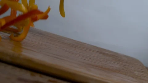 Slice bell peppers falls on the chopping board in slow motion Stock Footage 100008215