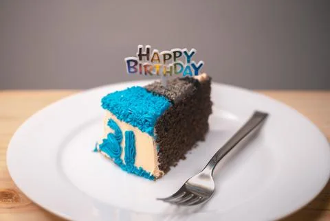 Slice of birthday cake with a silver fork on a white round plate. Colorful .. Stock Photos