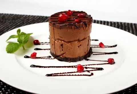 A slice of black chocolate cake with red cherry Foto stock