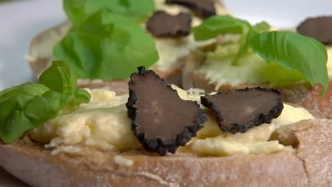 A slice of black truffle falls on a ciabatta with cheese cream 스톡 동영상 263191159