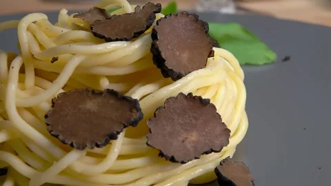 A slice of black truffle falls on spaghetti 스톡 동영상 263829267