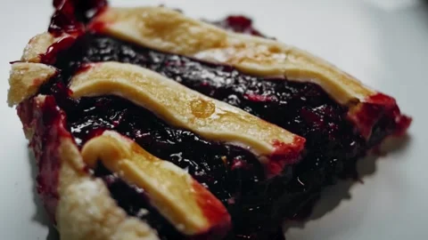 Slice of blueberry and raspberry pie with striped pastry, 4K Stock Footage 341118896
