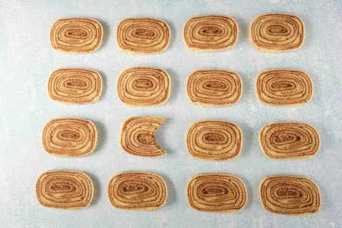 A slice of bolo de rolo with a bite surrounded by other slices. Stock Photos