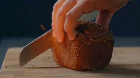 Slice Borodino bread on a wooden kitchen board Warm and delicious homemade loaf Stock Footage 129556911