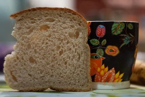 A slice of bread and a mug Stock Photos