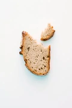 A slice of bread with a bite taken out Stock Photos