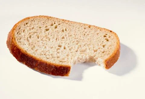 A slice of bread with a bite taken Stock Photos