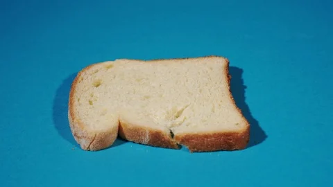 Slice of bread breaks in two Stock Footage 125244706