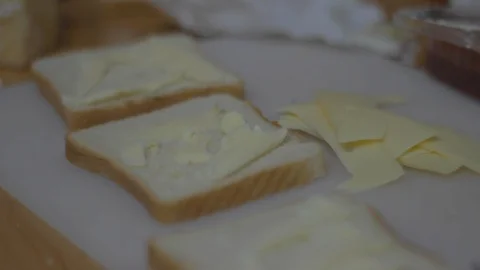 Slice of bread with butter and cheese on the kitchen table Stock Footage 105240959