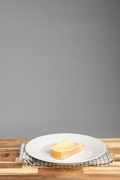 Slice of Bread with Cheese on White Plate Stock Photos