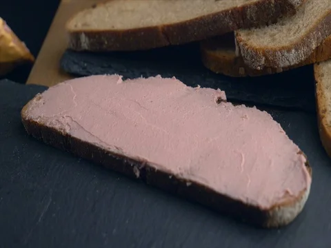 Slice of bread coated with liver pate Stock-Footage 76633453