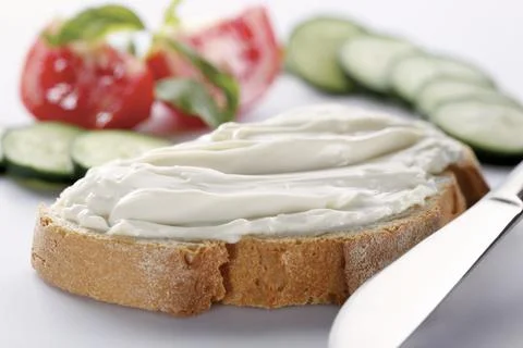 Slice of bread with cream cheese (selective focus) Stock Photos