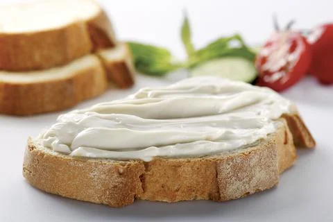 Slice of bread with cream cheese (selective focus) Stock Photos