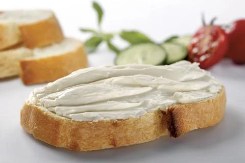 Slice of bread with cream cheese (selective focus) Stock Photos