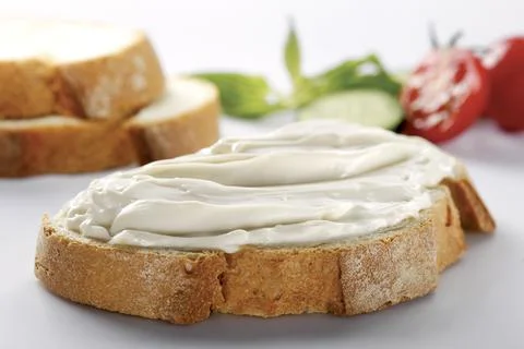 Slice of bread with cream cheese (selective focus) Stock Photos